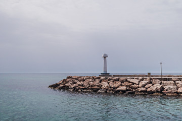 Lighthouse at sea on a cloudy day