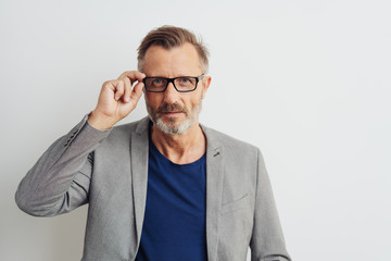 Man wearing glasses staring intently at the camera