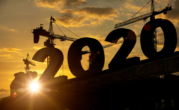 Silhouette construction site,Cranes building construction 2020 year sign