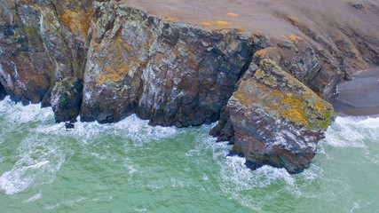 Storm waves run on the rocky coast.