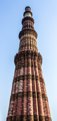 Fototapeta na wymiar Detail view on Qutb Minar with motifs on upper levels. UNESCO World Heritage in Mehrauli, Delhi, India, Asia.
