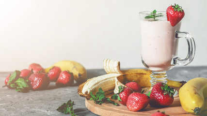 banana and strawberry smoothies with mint on the table, front view - 307581588