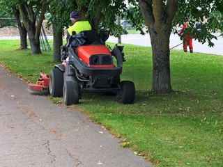 Fototapeta premium cutting the grass of on a tractor lawn mower