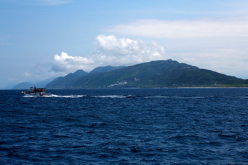 A beautiful island in the Pacific, her name is Formosa, and a fishing boat is crossing her