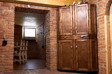 Antique wooden cabinet in a brick cellar. The interior of the vintage wine brick cellar pub (restaurant, bar)