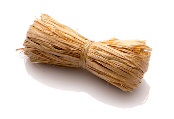 Roll of natural raffia on a white background