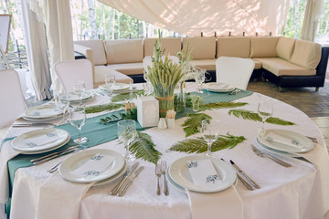 Table setting with sparkling wineglasses and cutlery on table, copy space. Menu mockup, place setting at wedding reception. Table served for wedding banquet in restaurant