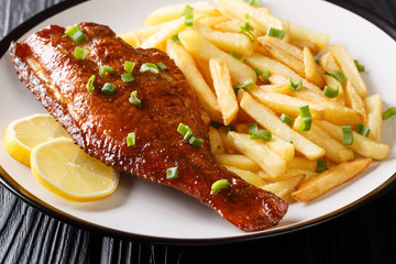 Fried Sebastes served with French fries close-up in a plate. horizontal