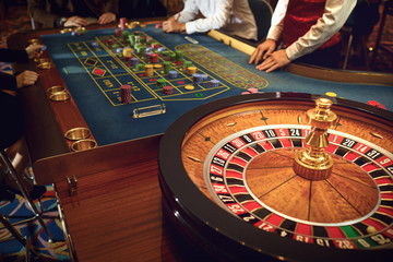 People gambling at roulette poker in a casino.