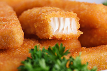 Fish fingers sticks with parsley.