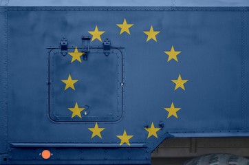 European union flag depicted on side part of military armored truck closeup. Army forces conceptual...