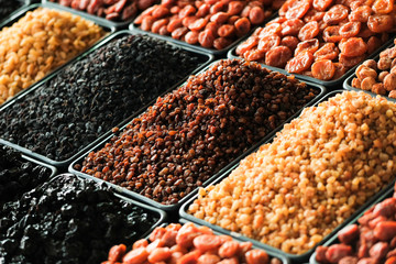 Dried berries on the counter. Raisins, dried apricots, prunes. Vegan food