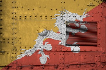 Bhutan flag depicted on side part of military armored tank closeup. Army forces conceptual background