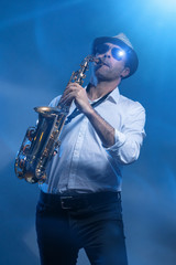 Man playing sax in cold blue laserlight