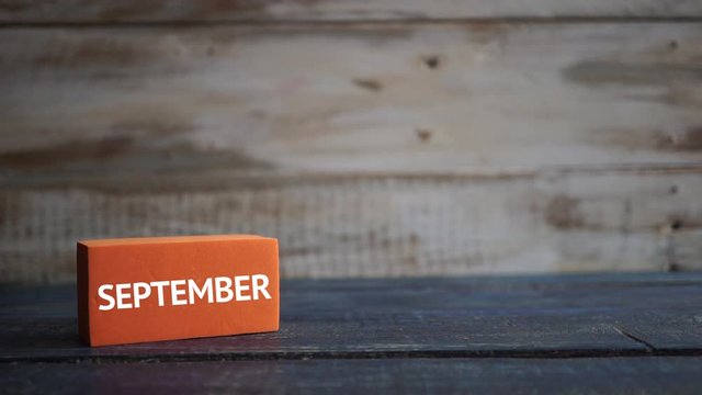september 3rd. Day 3 of month, calendar on a color cubes. hand puts the day of the month on the name of the month on a wooden background autumn, day of the year concept