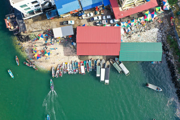 Fototapeta na wymiar Aerial view of domestic transport using wooden boat from island to the local market in Semporna, Sabah, Malaysia.