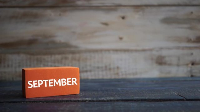 september 23rd. Day 23 of month, calendar on a color cubes. hand puts the day of the month on the name of the month on a wooden background autumn, day of the year concept