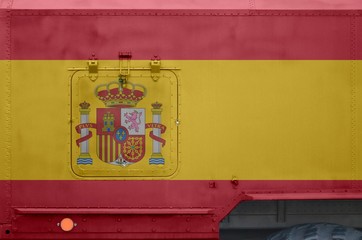 Spain flag depicted on side part of military armored truck closeup. Army forces conceptual...