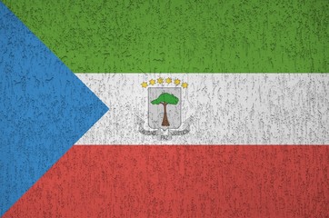 Equatorial Guinea flag depicted in bright paint colors on old relief plastering wall. Textured...