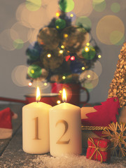 Two Advent candles burning with gift boxes, vintage tone stylized