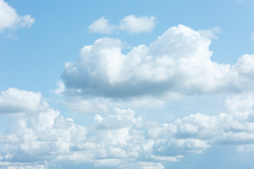 Naklejka na ściany i meble White and thick clouds in a blue sky. Cloudy sky.