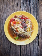 Papaya salad Thai food on wood background