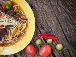 Papaya salad Thai food on wood background