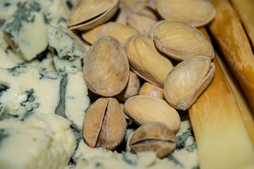 Salt-fried pistachios, Gorgonzola and smoked cheese. Close up