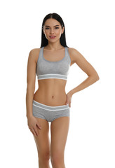 Beautiful young woman in grey sportive underwear isolated on white