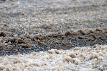 De-icing chemicals and sand on the winter road