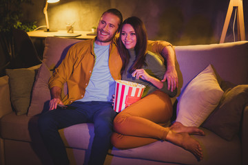 Portrait of his he her she nice attractive lovely cheerful cheery married spouses sitting on divan...