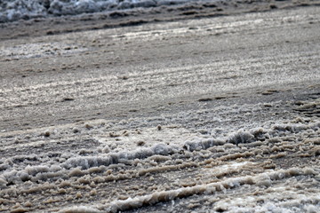 De-icing chemicals and sand on the winter road
