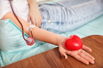 Teenager donating blood in hospital, closeup view