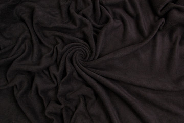 Fleece fabric black top view. Texture of textile fleece bedspread.