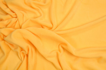 Fleece fabric yellow top view. Texture of textile fleece bedspread.