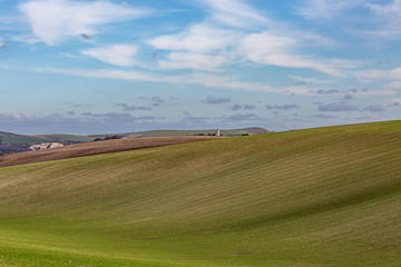 Fototapeta na wymiar Looking out over gentle rolling hills in the Sussex countryside, on a sunny winters day