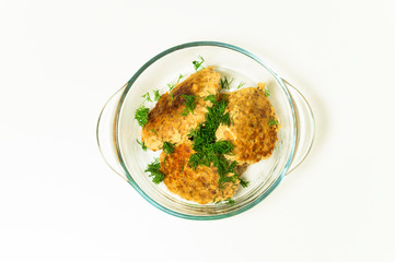 fish cutlets on a white background in a transparent plate