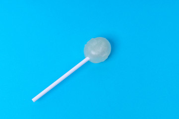 melon-flavored Lollipop on blue background background, mock up, copy space, text space