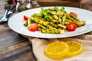 Pasta with pesto sauce and nuts on a the table