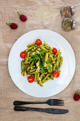 Pasta with pesto sauce and nuts on a the table