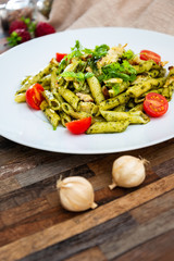 Pasta with pesto sauce and nuts on a the table