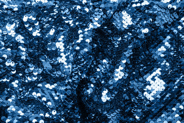 Luxury blue background with iridescent sequins on fabric. Trend duotone backdrop