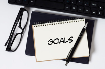 Business and finance concept. Goals word on notepad