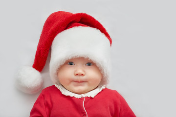 Cute little baby in red santa claus clothes. Horizontal image on a white background. New Year greeting card or banner