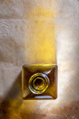 Extra virgin olive oil in glass bottle. Rustic Background. Top view.