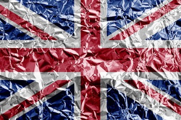 Great britain flag depicted in paint colors on shiny crumpled aluminium foil closeup. Textured banner on rough background - Powered by Adobe