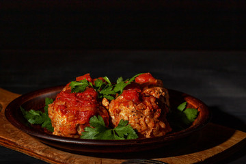 Delicious minced meatballs in spicy tomato sauce served on a clay dish