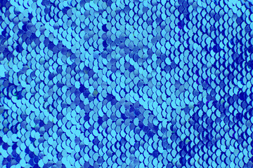 Pieces of cloth with blue sequins. Glitter background. Sequin texture