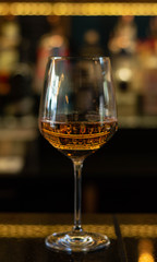 Wine in a wineglass with bokeh and reflection 