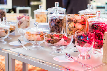 Obraz na płótnie Canvas Shortbread cookies in glassware and other sweets on the buffet table during the coffee break